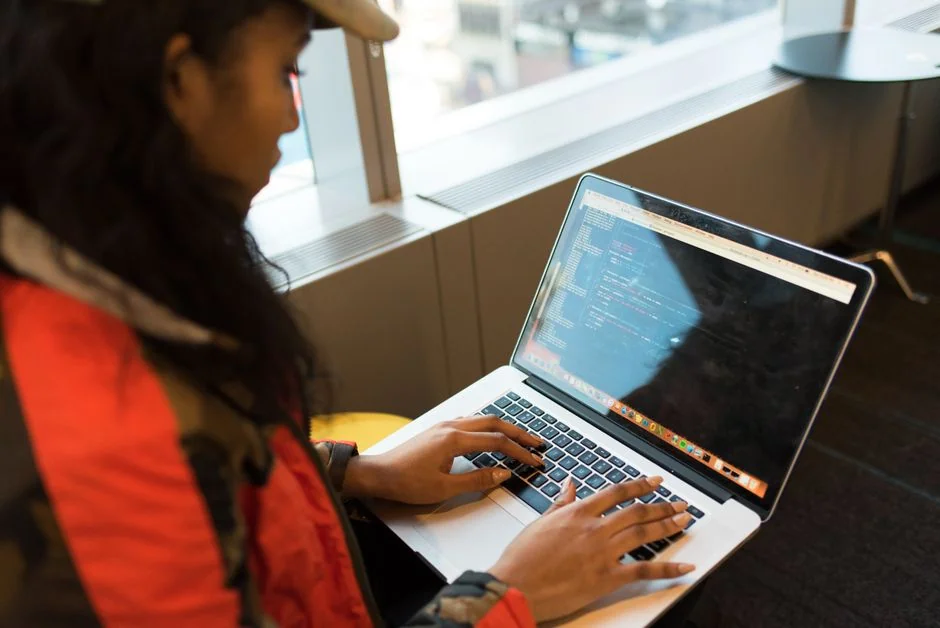 Overhead view of a corporate team collaborating with laptops and documents.